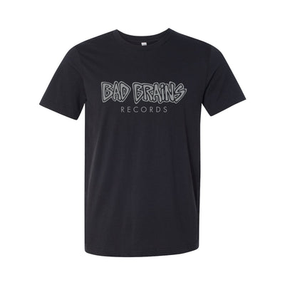Image of a black tshirt against a white background. Across the chest in grey lettering is the bad brains logo. It says bad brains on one line across the chest in larger lettering, and below it in smaller lettering it says "records". The text is centered on the tshirt.