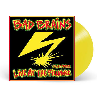 Image of a vinyl sleeve and yellow vinyl against a white background. The vinyl sleeve is a Photo of the bad brains- live at the fillmore album artwork. The artwork has a red border and is filled with black. On top of the background it says Bad brains at the top in red with a yellow outline and outlined again in green. At the bottom in red with yellow and green outline it says 3/20/1982 live at the fillmore. The middle of the artwork features a yellow lightning bolt.
