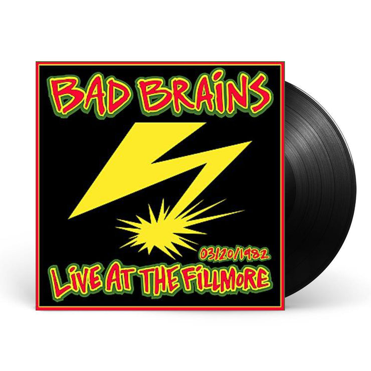 Image of a vinyl sleeve and black vinyl against a white background. The vinyl sleeve is a Photo of the bad brains- live at the fillmore album artwork. The artwork has a red border and is filled with black. On top of the background it says Bad brains at the top in red with a yellow outline and outlined again in green. At the bottom in red with yellow and green outline it says 3/20/1982 live at the fillmore. The middle of the artwork features a yellow lightning bolt.