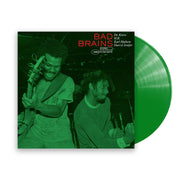 Image of a vinyl sleeve and vinyl against a white background. The vinyl is green. The sleeve is a photo of the Bad Brains Punk Note Edition artwork. The artwork is an image of two men playing instruments next to each other and the image is in green. One looks happy while the other looks focused. Above their heads on the top right in red text says Bad Brains. In white text next to it says Dr. Know, H.R., Earl Hudson, Darryl Jenifer. Under the bad brains words says 1982, stereo, punk note in white.