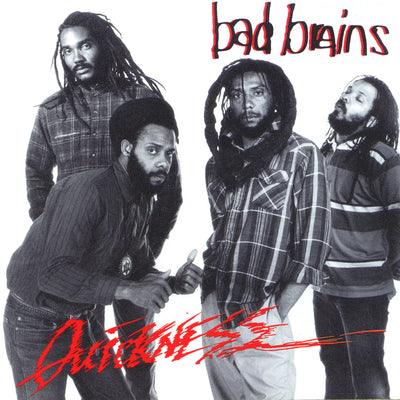 Image of the Bad brains- quickness album artwork. The artwork is a black and white image of the 4 band members. two band members on the left look at the camera, not smiling. One has his hands in his pockets while the other does a thumbs up. The third member faces the two on the left with his hands in his pockets, slightly smiling. The fourth member has his eyes closed as if he is asleep. The top right in black writing with a red outline says bad brains. The bottom left in red writing says quickness.